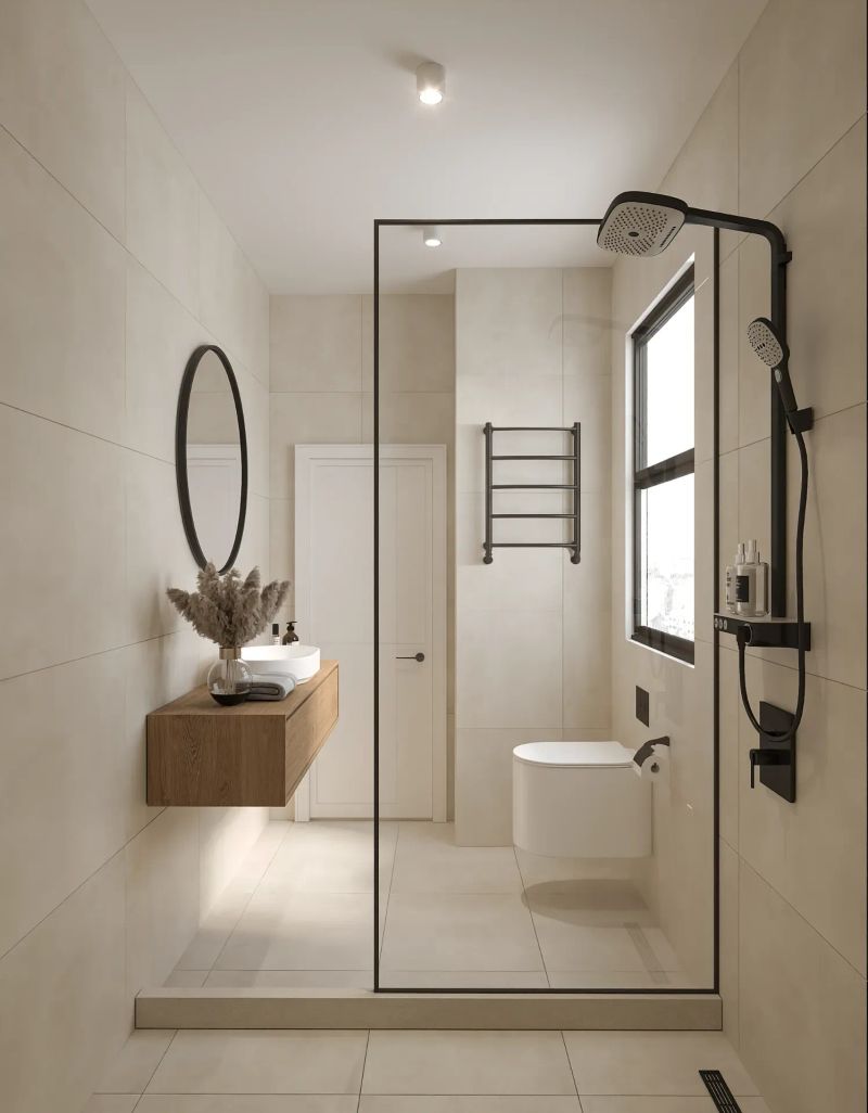 Modern bathroom with floating vanity, oval mirror and walk-in glass shower